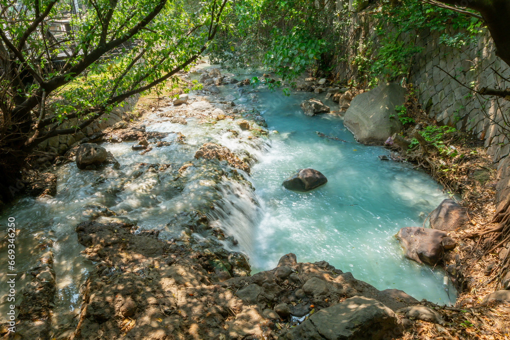 Obraz premium Beautiful nature river water from outdoor waterfall, slow flowing stream with rock and green tree in forest mountain no people tranquil, flowing water scenic landscape environment park in summer
