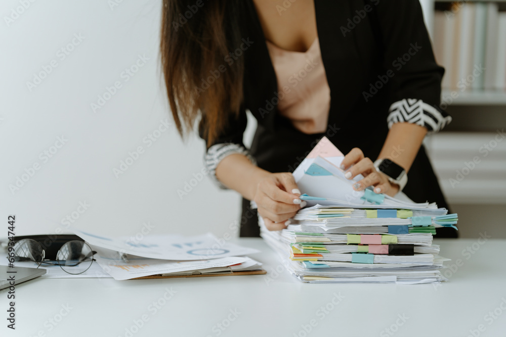Businessman man working in stacks of papers searching for unfinished ...