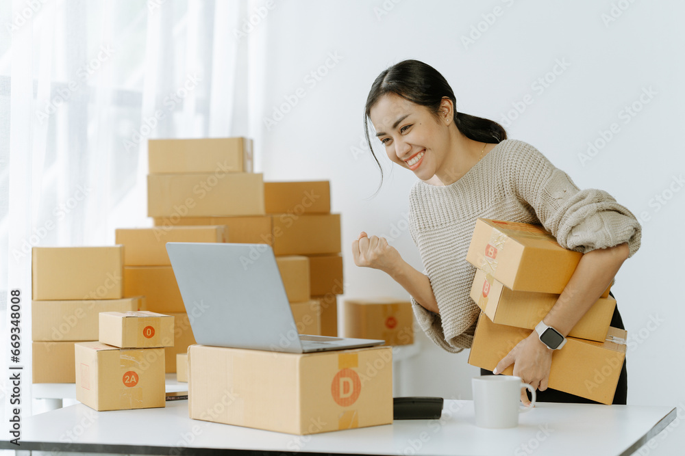 ortrait of a small business startup, SME owner, female entrepreneur, working, unboxing, checking orders online. To prepare to pack boxes for sale to SME customers online business ideas ortrait of a small business startup, SME owner, female entrepreneur, working, unboxing, checking orders online. To prepare to pack boxes for sale to SME customers online business ideas