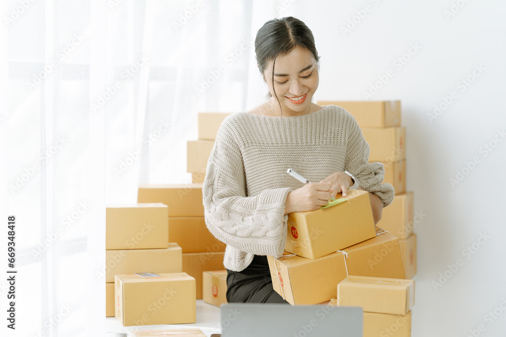 Small start-up business owners checking parcels at work, salespeople, checking production orders. Pack products for delivery to customers Sell Ecommerce Shipping Ideas Small start-up business owners checking parcels at work, salespeople, checking production orders. Pack products for delivery to customers Sell Ecommerce Shipping Ideas