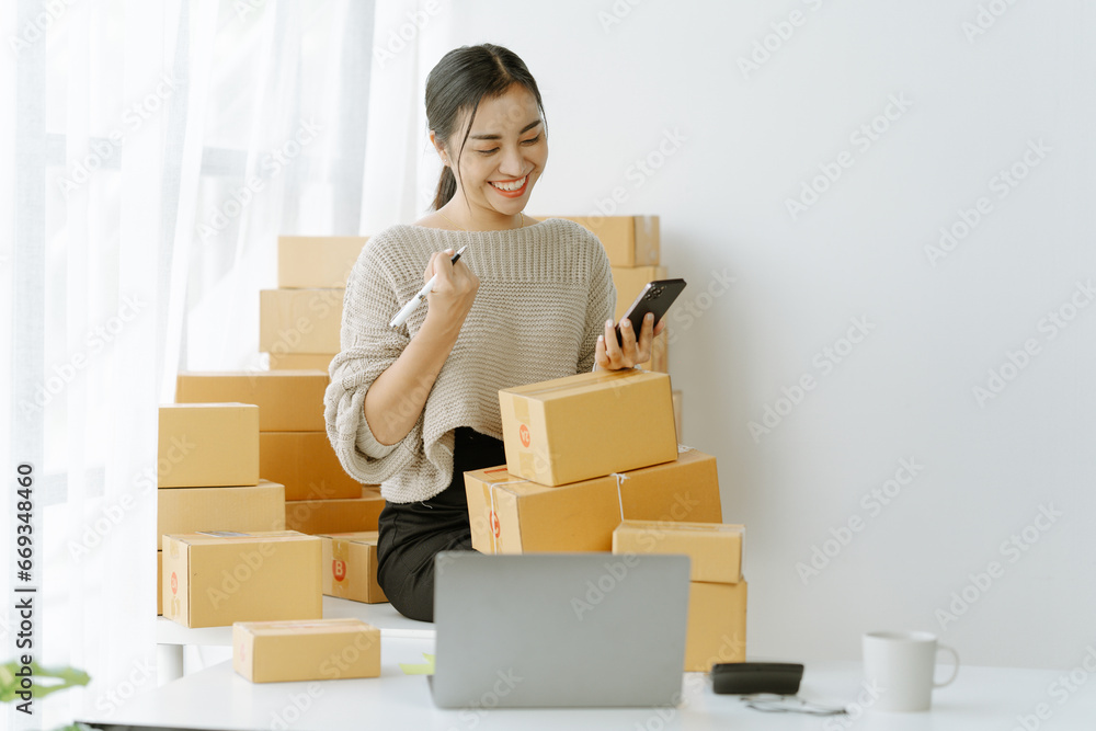 Small start-up business owners checking parcels at work, salespeople, checking production orders. Pack products for delivery to customers Sell Ecommerce Shipping Ideas Small start-up business owners checking parcels at work, salespeople, checking production orders. Pack products for delivery to customers Sell Ecommerce Shipping Ideas