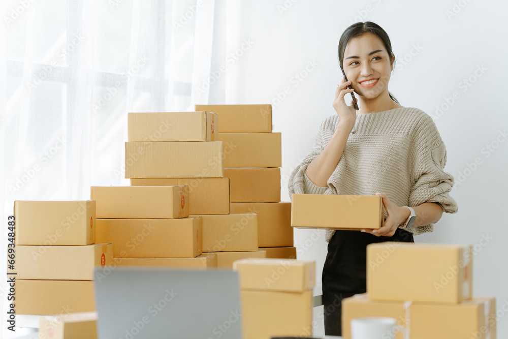 Small start-up business owners checking parcels at work, salespeople, checking production orders. Pack products for delivery to customers Sell Ecommerce Shipping Ideas Small start-up business owners checking parcels at work, salespeople, checking production orders. Pack products for delivery to customers Sell Ecommerce Shipping Ideas