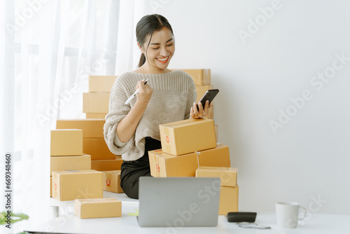 Small start-up business owners checking parcels at work, salespeople, checking production orders. Pack products for delivery to customers Sell ​​Ecommerce Shipping Ideas photo