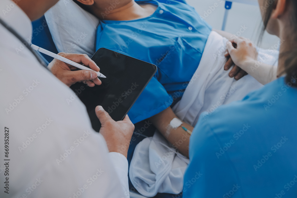 Women Asian doctors hold the patient hand and encourage and provide medical advice While checking the patient health in bed. Concept of Care and compassion, antenatal care, Threatened abortion Women Asian doctors hold the patient hand and encourage and provide medical advice While checking the patient health in bed. Concept of Care and compassion, antenatal care, Threatened abortion