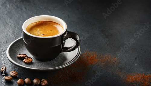 Espresso served in cup on dark with copy space