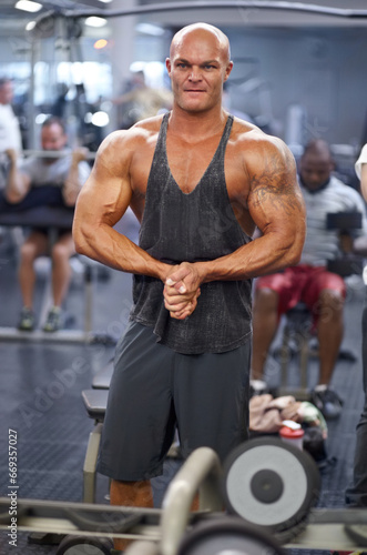 Man  arm flex and mirror at gym with fitness  workout and exercise of bodybuilder with reflection. Muscle  male person and athlete with sport training  wellness and body builder at a health club