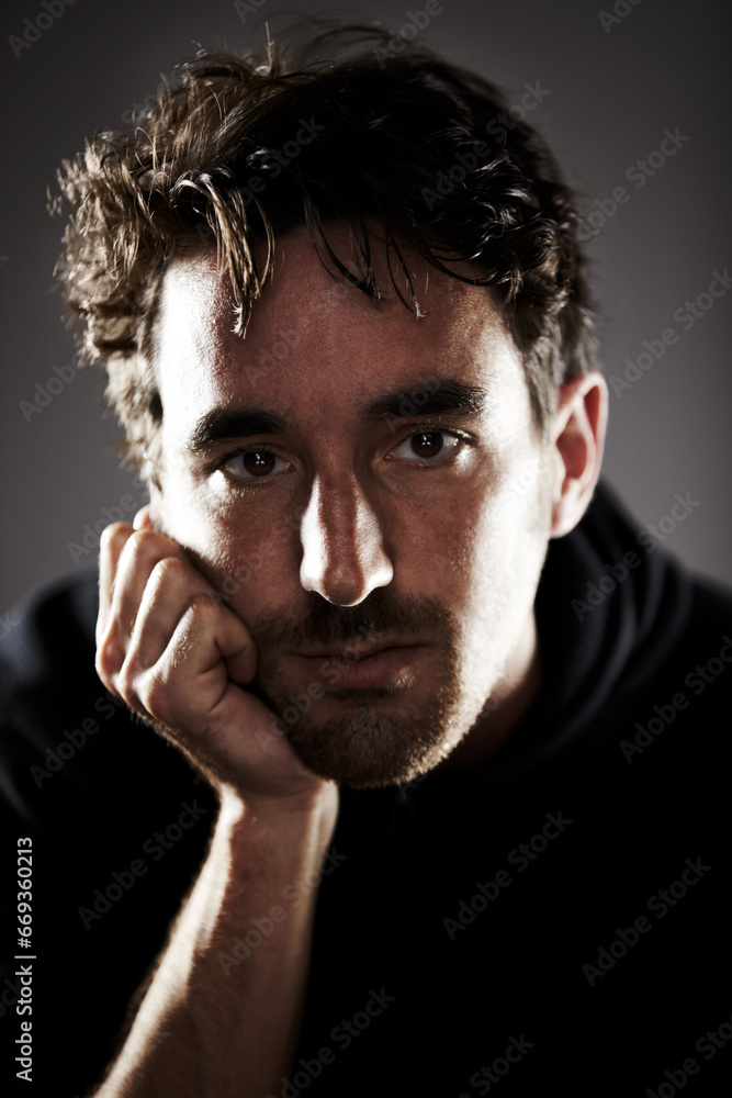 Man, depression and portrait, sad with mental health and crisis in studio, feelings and grief on grey background. Pain, wellness and depressed, trauma or abuse, distress and upset with psychology Man, depression and portrait, sad with mental health and crisis in studio, feelings and grief on grey background. Pain, wellness and depressed, trauma or abuse, distress and upset with psychology