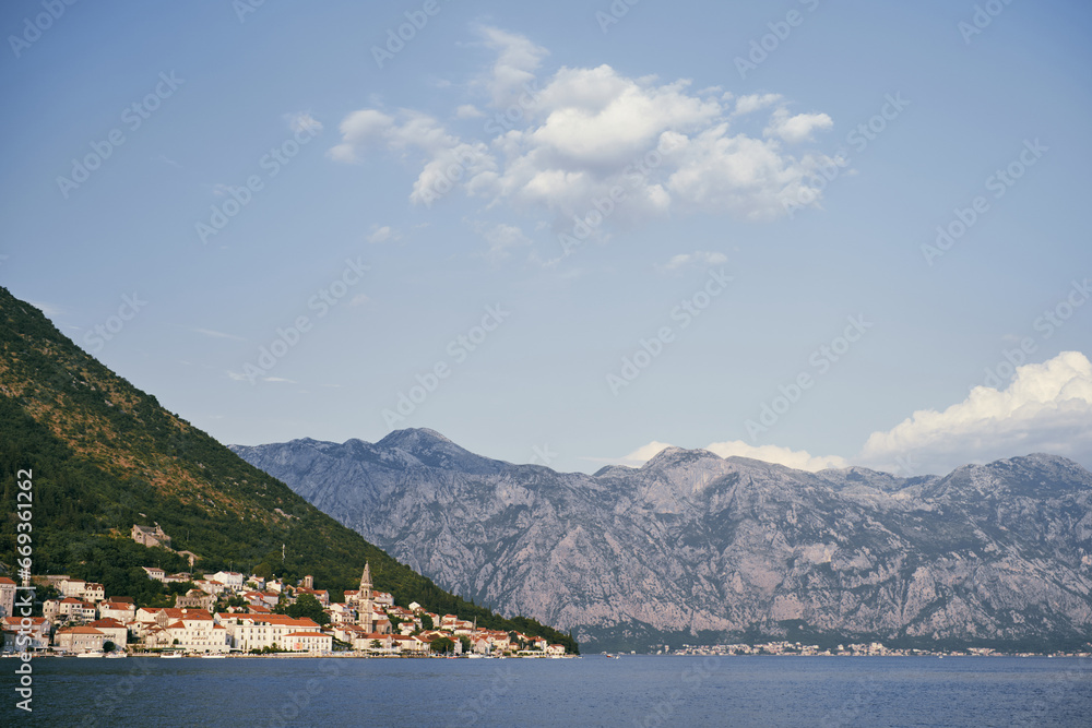 View from the sea to the ancient town of Perast at the foot of the mountains. Montenegro