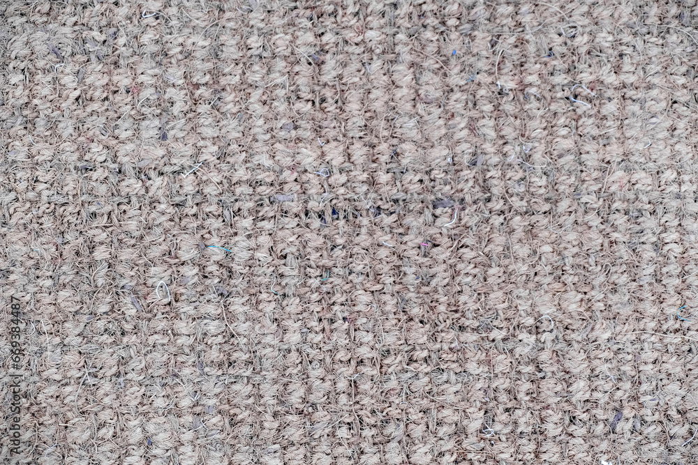 Jute knitted fabric, Handmade: jute and crochet hooks, a circle of jute is tied, close-up, background, texture. Jute knitted fabric, Handmade: jute and crochet hooks, a circle of jute is tied, close-up, background, texture.