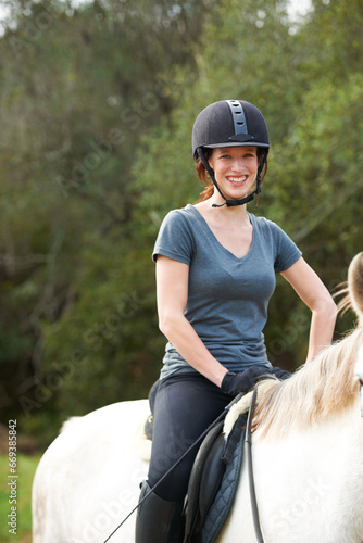 Horse riding, nature or portrait of happy woman in countryside outdoor with jockey for recreation. Sports, smile or female equestrian on an animal to start training, exercise or workout on a farm