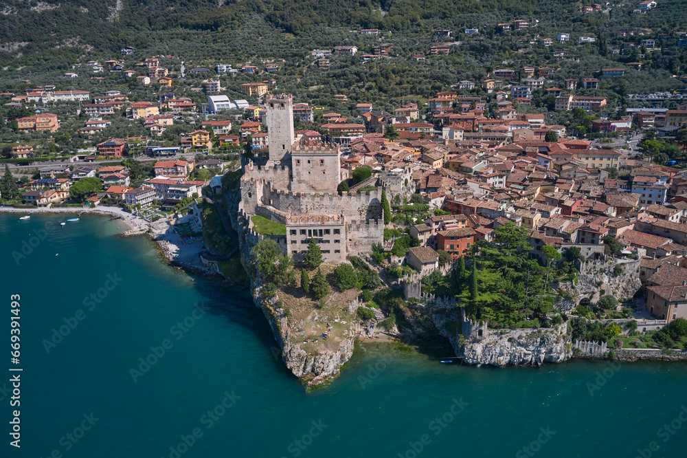 Malcesine is a small town on the shore of Lake Garda in Verona province, Italy. Malcesine and Lago di Garda aerial view, Veneto region of Italy.