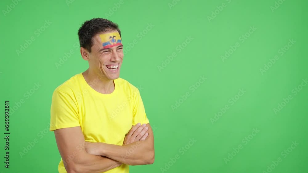 Happy man with ecuadorian flag painted on face looking away Happy man with ecuadorian flag painted on face looking away
