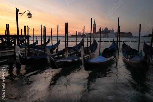 A new day among the Gondeles, Riva degli Schiavoni Venice Italy photo