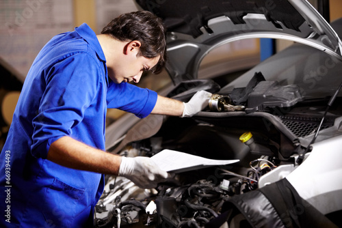Document, man and technician check engine of car, repair and maintenance. Checklist, mechanic and serious person on motor vehicle hood, inspection list or fixing transportation at auto service garage