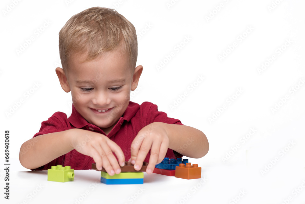 Little boy playing with building blocks 