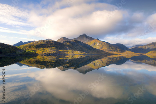 wonderful mountainous landscape in Norway reflected on the water surface like...