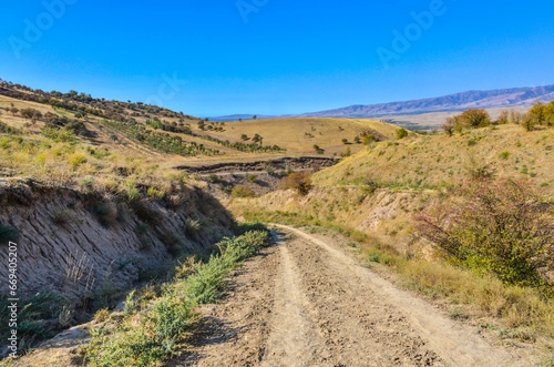 dirt road on scenic hills around Karankul in autumn (Tashkent region, Uzbekistan)
