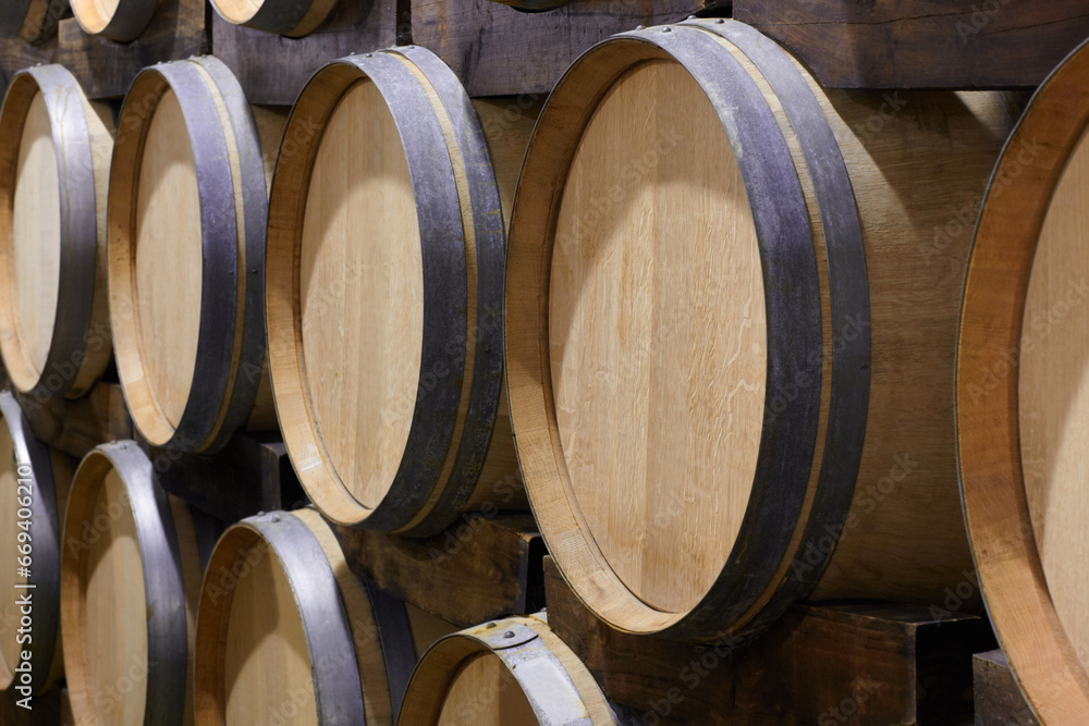 Background, wine cellar and barrel in brewery for beer production, alcohol manufacturing or whiskey fermentation. Closeup, wood cask container or liquor storage in winery, factory or distillery vault Background, wine cellar and barrel in brewery for beer production, alcohol manufacturing or whiskey fermentation. Closeup, wood cask container or liquor storage in winery, factory or distillery vault