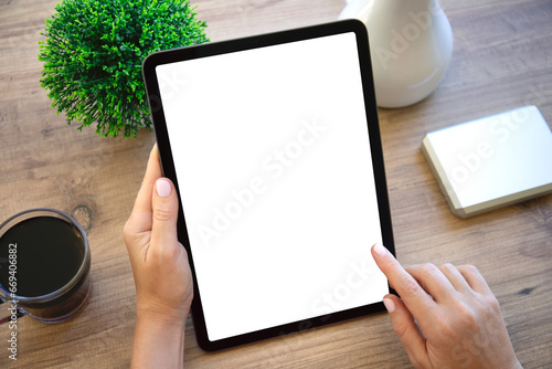 female hands hold computer tablet with isolated screen in office photo
