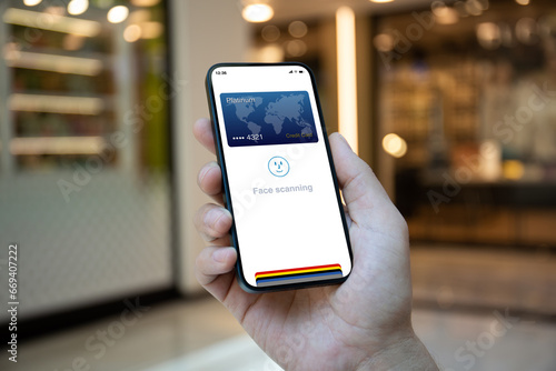 Male hands holding phone with face scanning id on screen