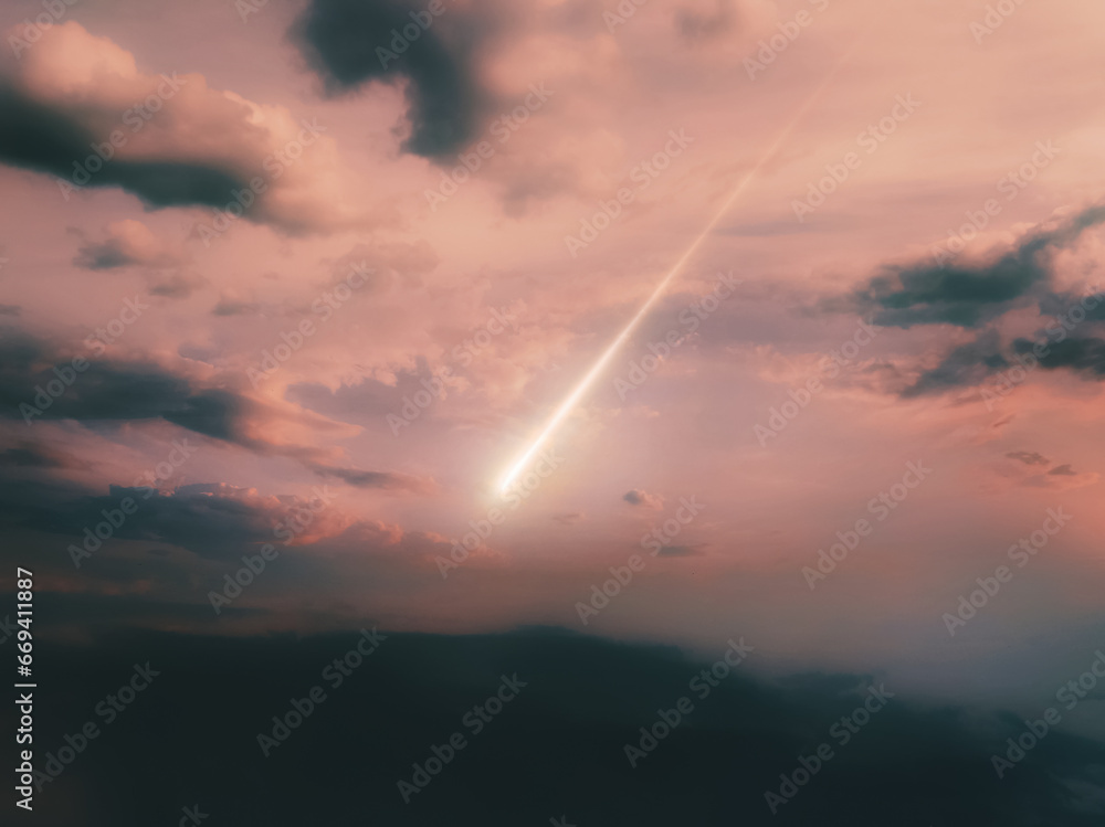 Bright fireball at sunset. Meteor trail against a cloudy sky. Meteorite falling.