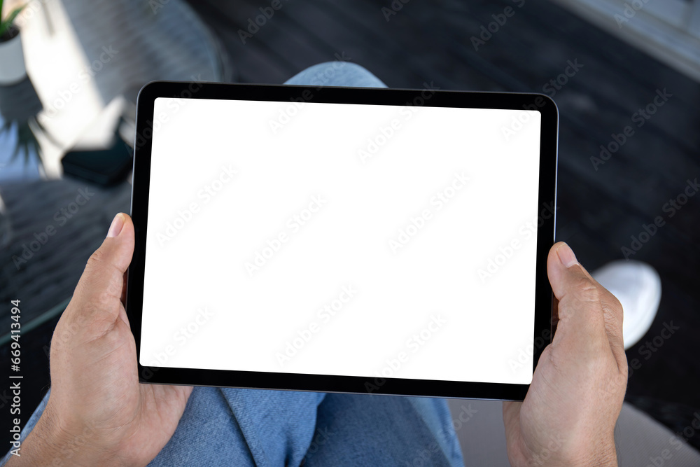 Male hands holding computer tablet with isolated screen in office