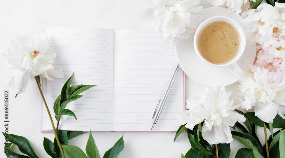 Top view of morning coffee cup, diary and white peonies flowers on white table - obrazy, fototapety, plakaty 