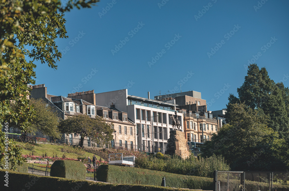 Edinburgh a picturesque hillside with a cluster of buildings nestled among the greenery