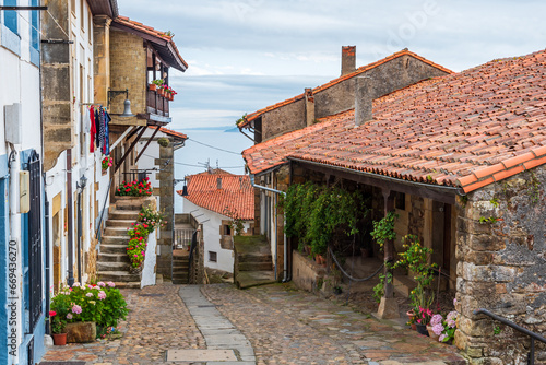 Cobblestone street of old houses in the town of Lastres, overlooking the Cantabrian Sea, Asturias.