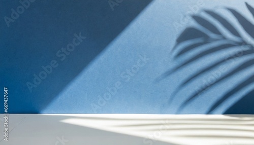 Minimal abstract blue and white background for presentation of a cosmetic product.. The premium podium features tropical palm leaf silhouettes against a green wall and a white table. Display box