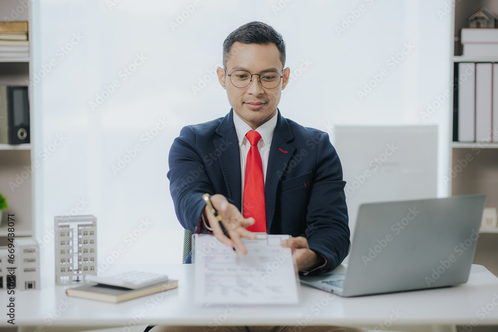 Real estate agents offer condos to clients. A real estate agent is talking with a client about buying and selling assets, houses, condos. Real estate agents offer condos to clients. A real estate agent is talking with a client about buying and selling assets, houses, condos.