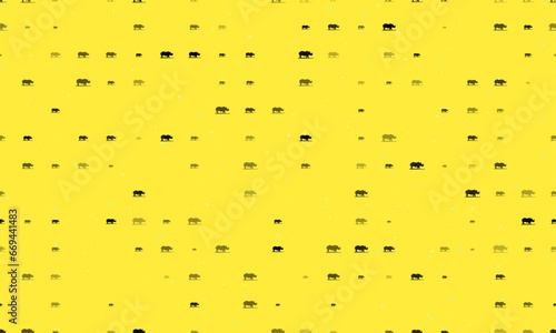 Seamless background pattern of evenly spaced black wild rhino symbols of different sizes and opacity. Vector illustration on yellow background with stars