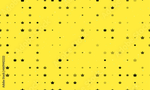 Seamless background pattern of evenly spaced black maple leaf symbols of different sizes and opacity. Vector illustration on yellow background with stars