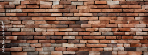 Ultrawide detailed close-up of a uniformly patterned brick wall, showcasing rich terracotta hues and rugged texture.
