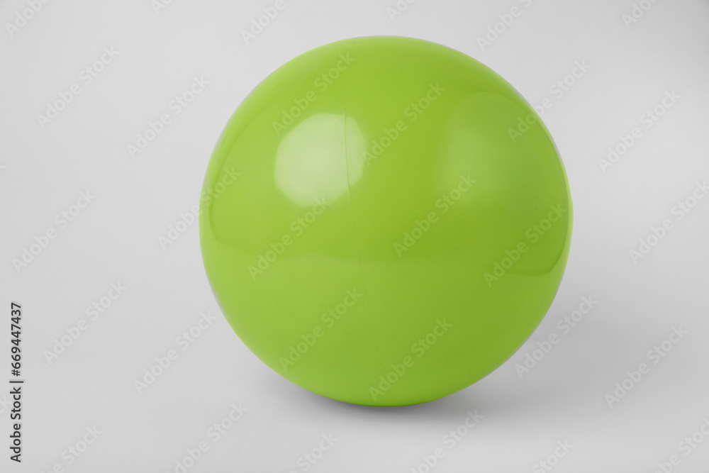 Light green inflatable beach ball on white background