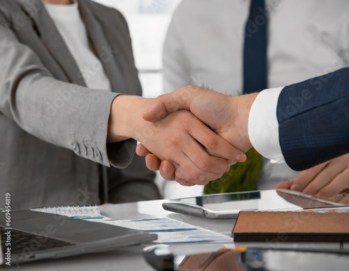 lose up of handshake in the office,young businesspeople shaking hands
