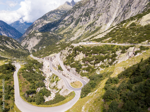 long and winding road to the Grimselpass, Scenic route over the Swiss alps in summer time.  For transportation and Tourism. Serpentine Road for transportation and Tourism. 