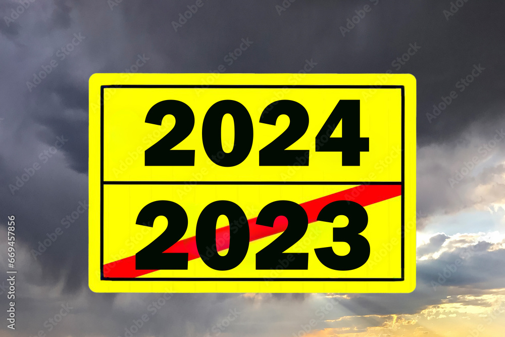 Year change 2023 2024 on a yellow sign Year change 2023 2024 on a yellow sign