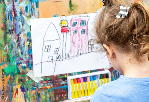 Little girl draws a picture. Selective focus