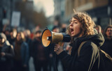 woman shouting through megaphone on the street over a crowd of people