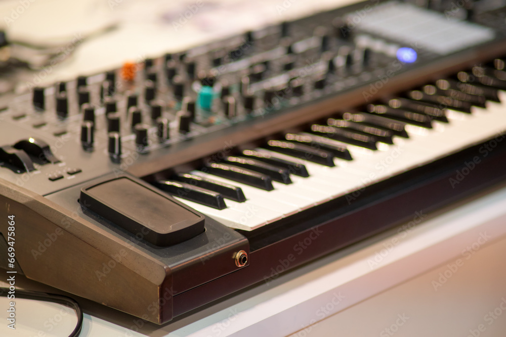 Black synthesizer and keyboard in a music studio, close up Black synthesizer and keyboard in a music studio, close up