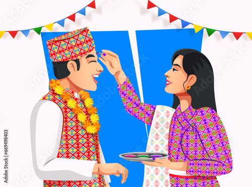 Sister applying tilak on forehead to brother on Bhai Tika or Raksha Bandhan. People in Nepali ethnic clothes