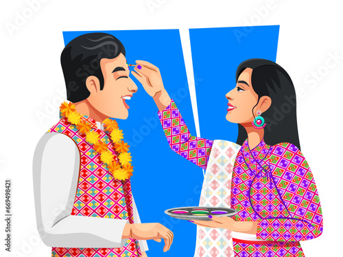 Nepali woman is giving blessings to the brother by putting tika on his forehead. Both wearing traditional ethnic clothes. Celebrating Bhai Tika or Bhai Tihar