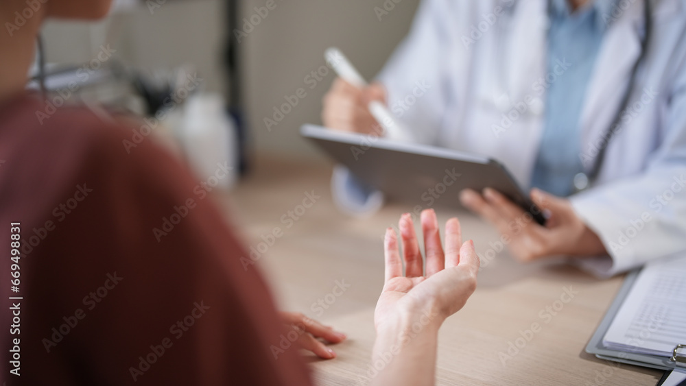 Asian patient women with anxiety explaining about psychological health problem to doctor while female psychologist writing notes on tablet and counseling about medicine and mental health therapy Asian patient women with anxiety explaining about psychological health problem to doctor while female psychologist writing notes on tablet and counseling about medicine and mental health therapy