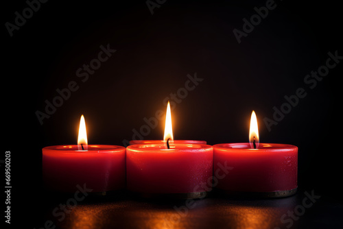 Group of four candle lights, with dark background, with space for text