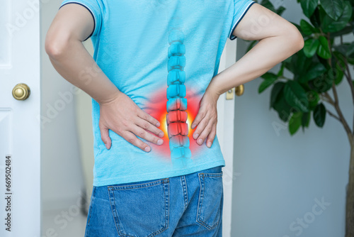 Lumbar intervertebral spine hernia, man with back pain at home, spinal disc disease photo