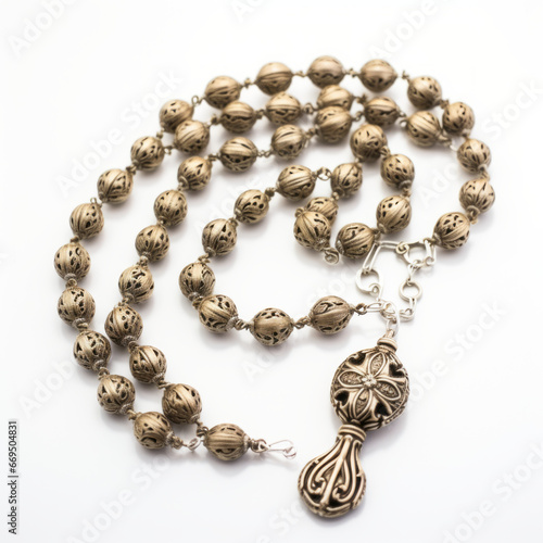 Carved metal rosary with a white backdrop