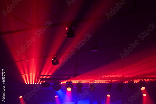 Red-lit venue with beams - concert lighting