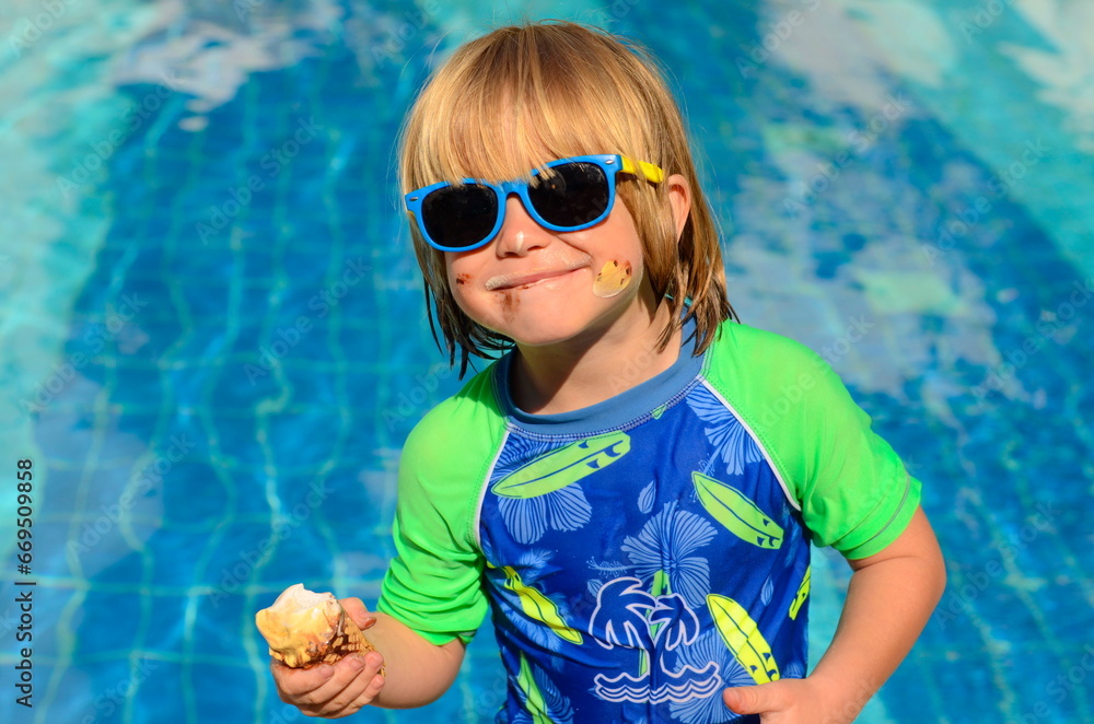 Swimming lessons at the hotel. Child at the resort. Boy in a bathing suit near the pool. Swimming lessons at the hotel. Child at the resort. Boy in a bathing suit near the pool.