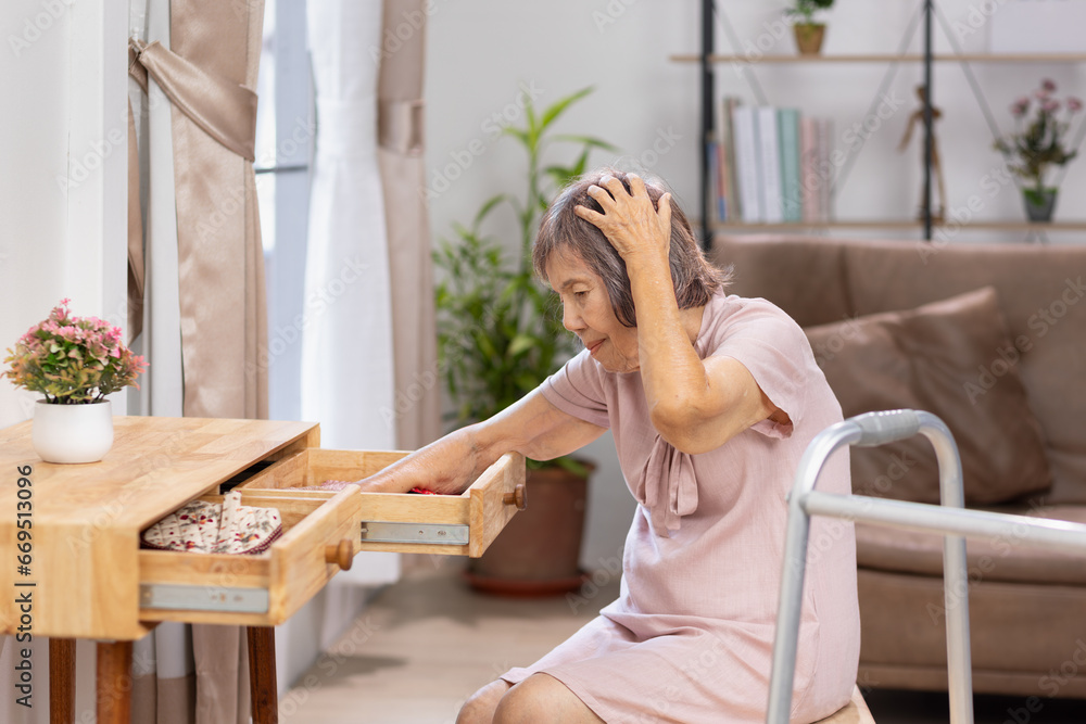 Asian Elderly woman looking for something that she forgot it in drawers. Asian Elderly woman looking for something that she forgot it in drawers.
